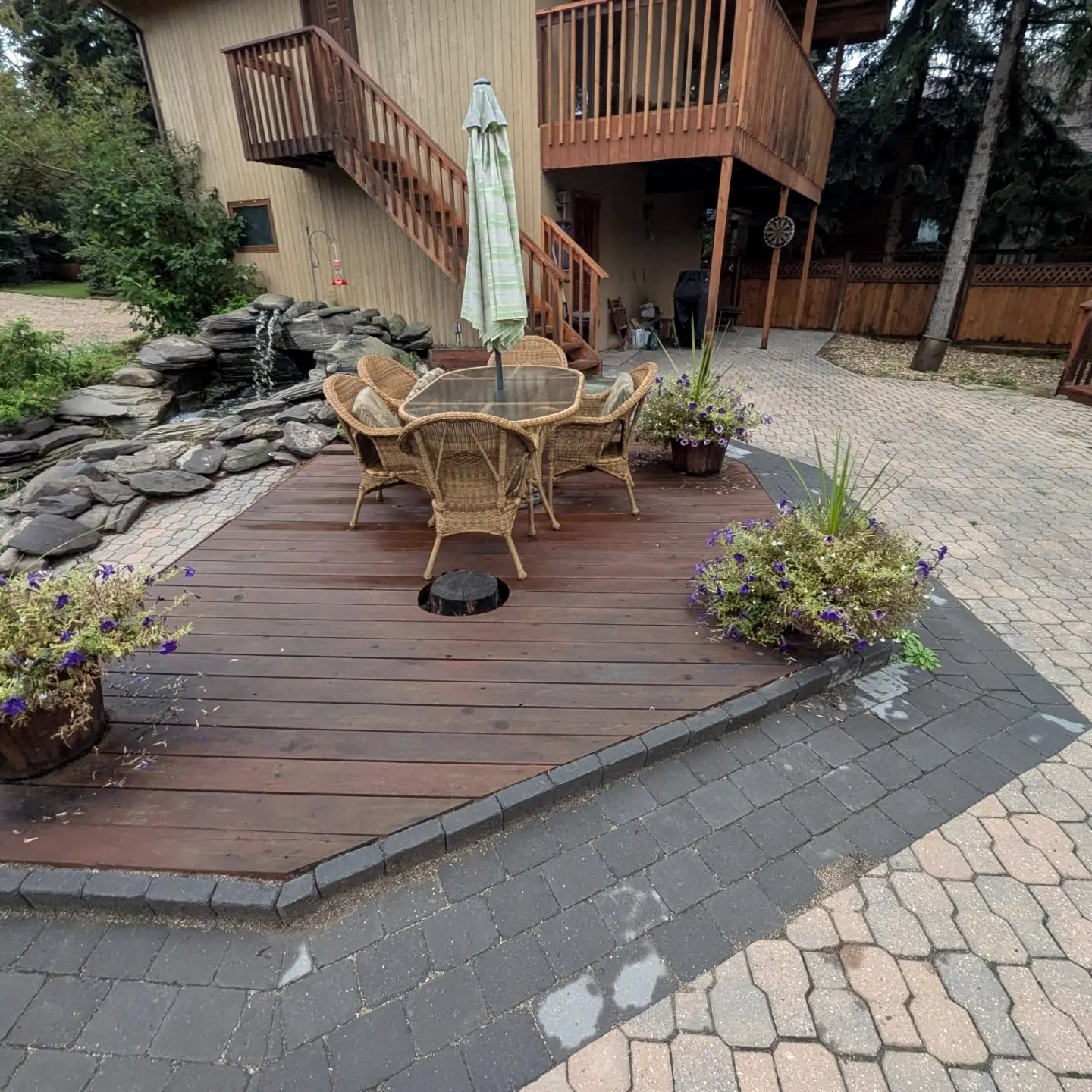 Angled deck set into pavers and planters