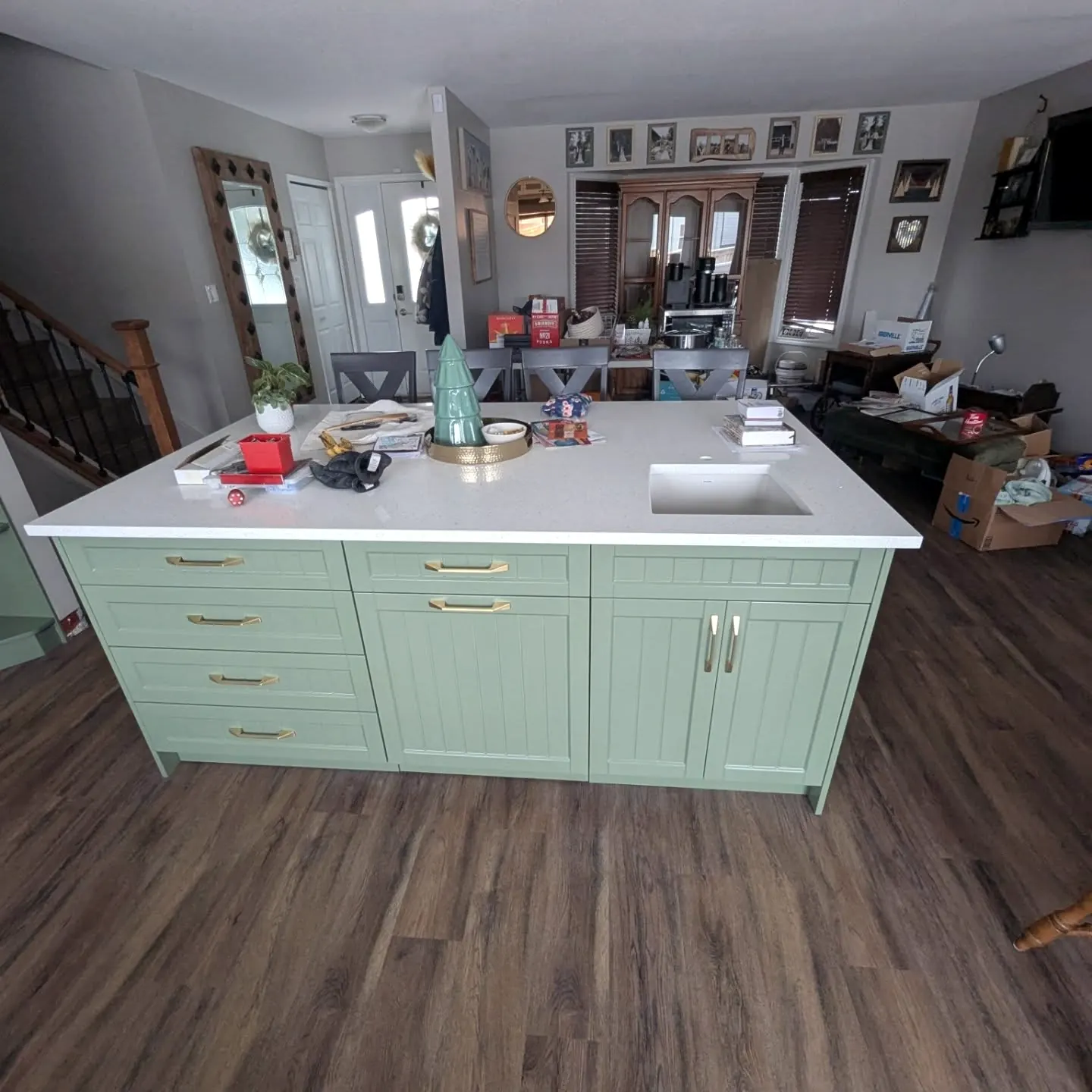Kitchen with a mint green island and white top