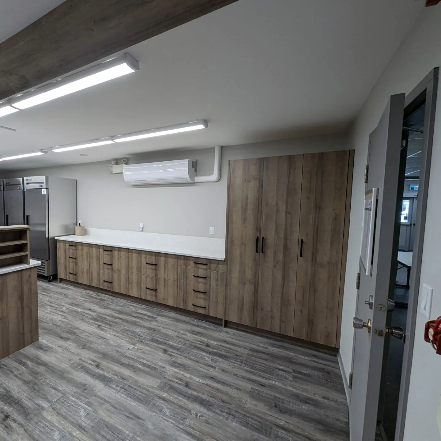 Rec room lined with woodgrain cabinets