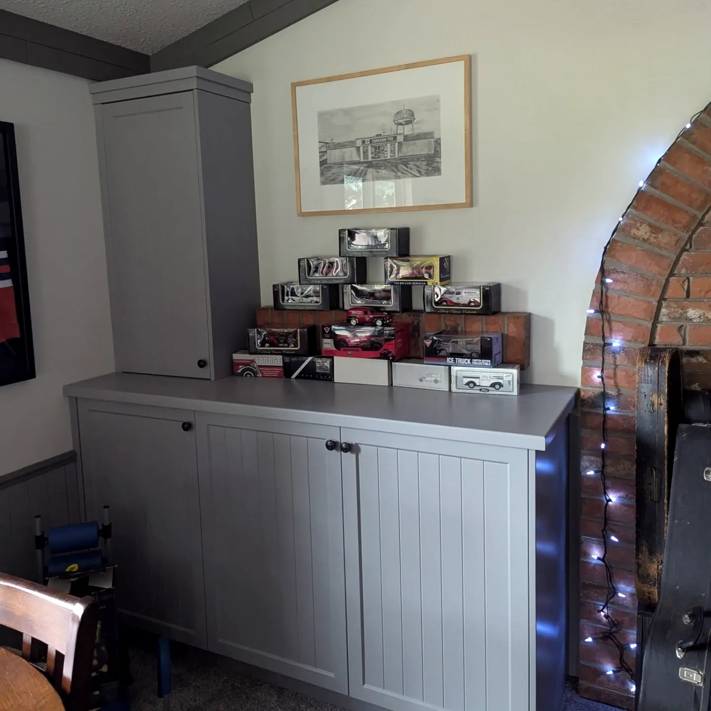 Grey shaker rec-room cabinets with a display shelf