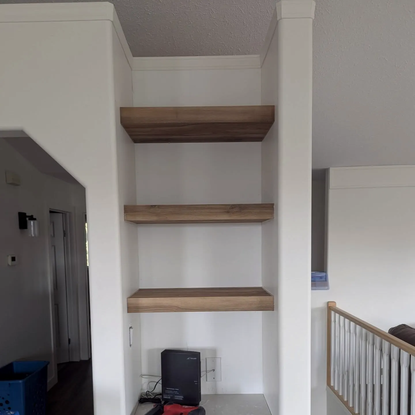 Floating wood shelves in a wall niche