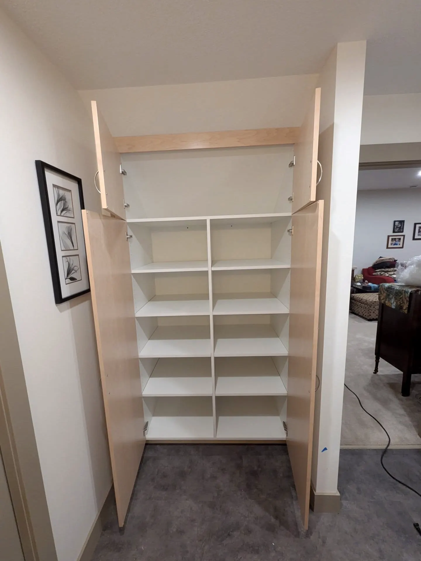 Linen unit open with white shelves inside