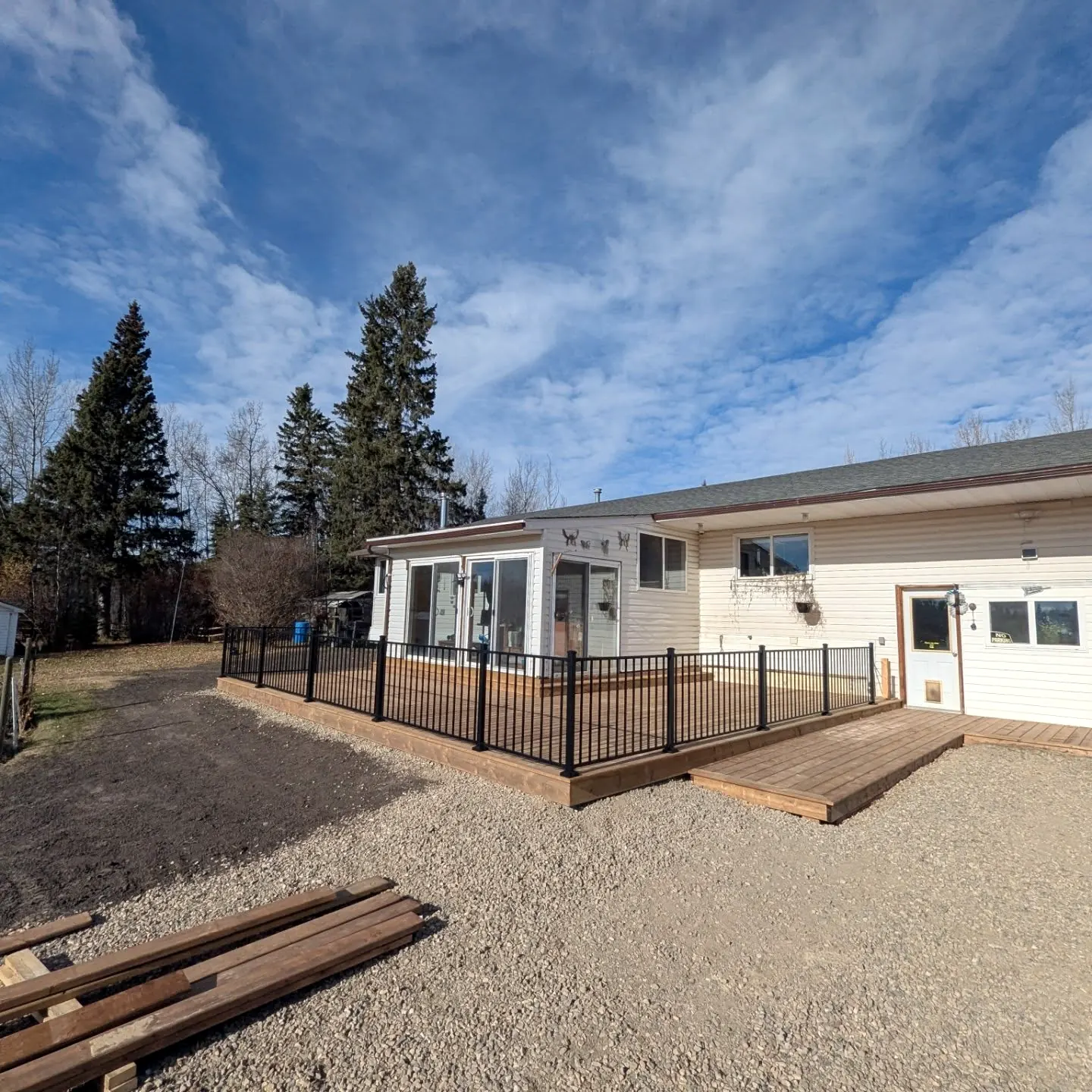 Deck with black metal railing and steps