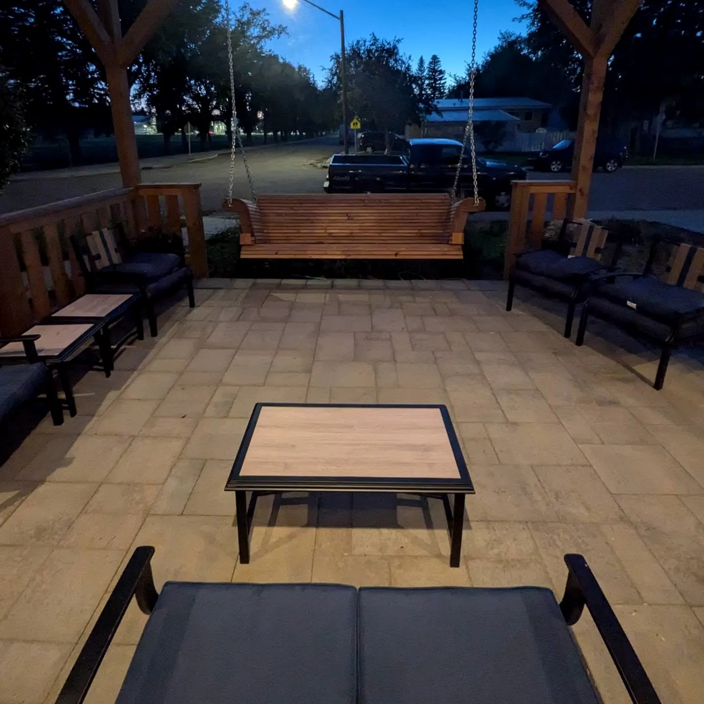 Pergola at night with the swing and patio seating