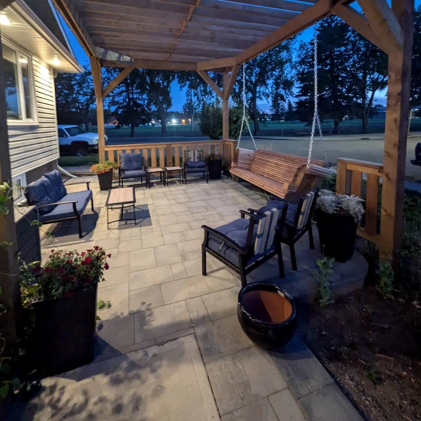 Pergola at dusk over patio furniture