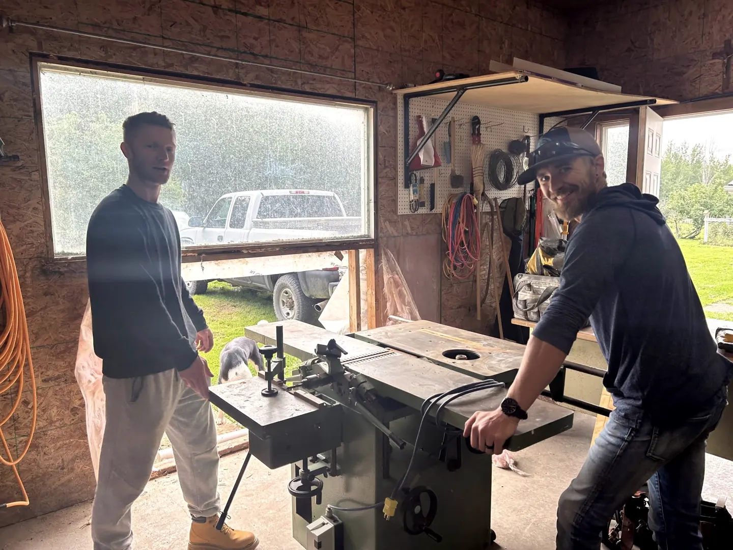 Nathaniel and a helper at the table saw in the Hurricane shop