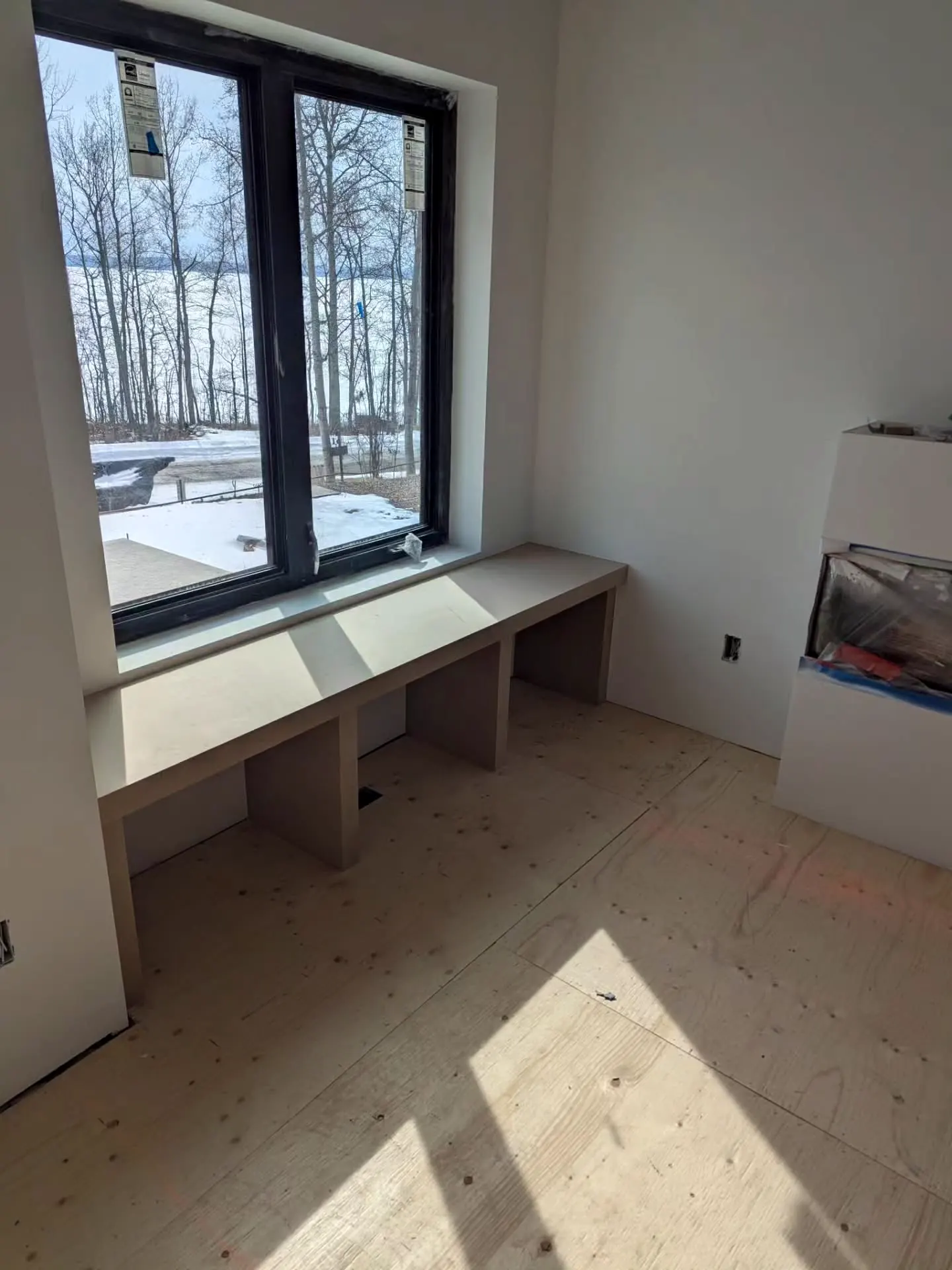 Bench seat under a big black window