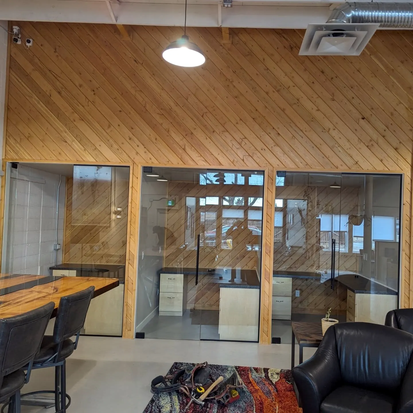Office with wood-clad walls and glass partitions